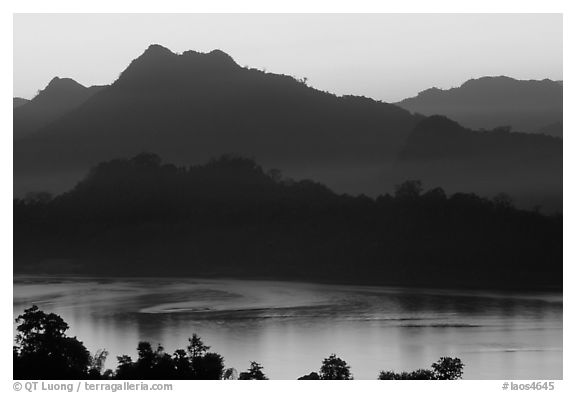 Hills, sunset on the Mekong river. Luang Prabang, Laos