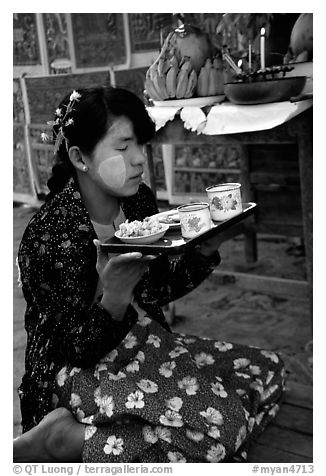 Burmese woman offering food. Bagan, Myanmar