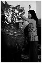 Rubbing an Angkor bronze statue at Mahamuni Paya. Mandalay, Myanmar ( black and white)