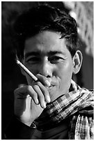 Man enjoying a cheerot (burmese cigar). Mandalay, Myanmar (black and white)