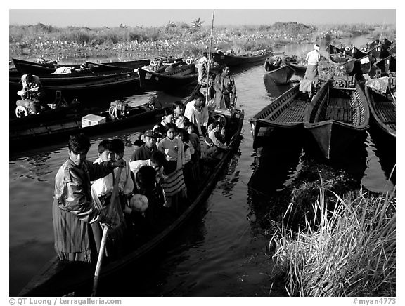 Children commuting to school on small boat. Inle Lake, Myanmar (black and white)