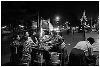 Streat food served at night, Shwedagon Pagoda in background. Yangon, Myanmar ( black and white)
