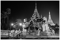 Southern gate guarded by two leogryphs and Main Stupa at night, Shwedagon Pagoda. Yangon, Myanmar ( black and white)