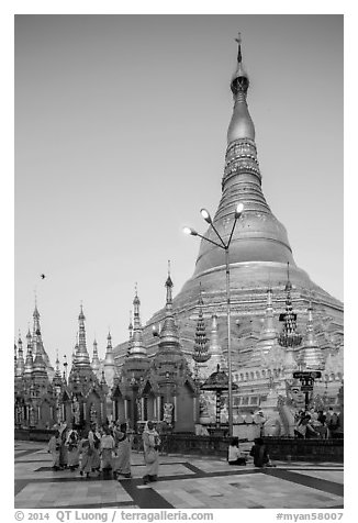 Nuns walking at the base of main chedi, Shwedagon Pagoda. Yangon, Myanmar (black and white)