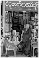Monk leaves bookstore, Shwedagon Pagoda. Yangon, Myanmar ( black and white)