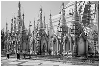 Men walking near stupas, Shwedagon Pagoda. Yangon, Myanmar ( black and white)
