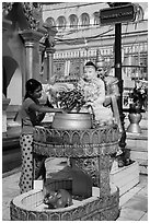 Woman worshipping at planetary post. Yangon, Myanmar ( black and white)