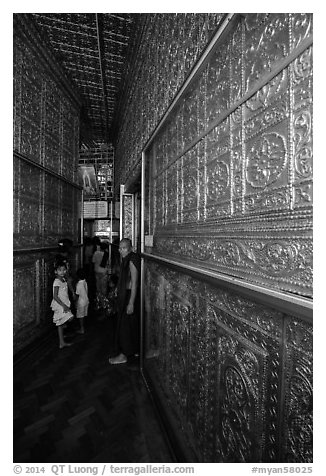 Worshippers inside maze-like walkway lined with glass showcases, Botataung Pagoda. Yangon, Myanmar (black and white)