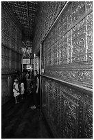 Worshippers inside maze-like walkway lined with glass showcases, Botataung Pagoda. Yangon, Myanmar ( black and white)