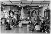 Visitors and altar, Botataung Pagoda. Yangon, Myanmar ( black and white)