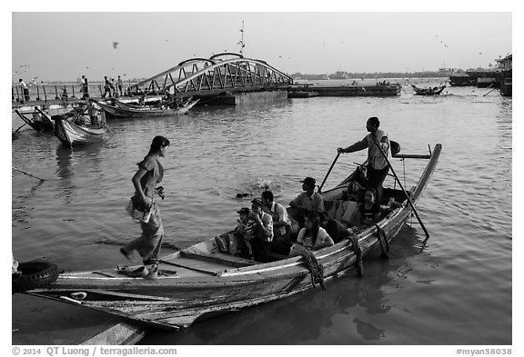 Woman boards boat to cross the Yangon River. Yangon, Myanmar (black and white)