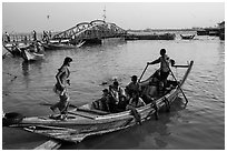 Woman boards boat to cross the Yangon River. Yangon, Myanmar ( black and white)