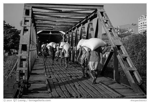 Workers unload bags of rice, Sinodan pier. Yangon, Myanmar (black and white)
