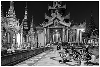 Praying on the platform at night. Yangon, Myanmar ( black and white)