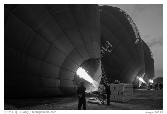 Crew inflates hot air balloons with propane burners. Bagan, Myanmar (black and white)