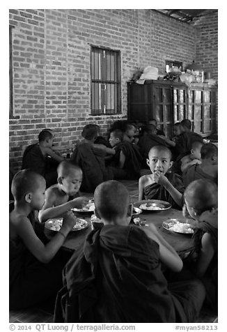 Young Buddhist monks in dining room. Bagan, Myanmar (black and white)