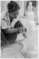 Stone sculptor finishing buddha statue. Mandalay, Myanmar ( black and white)