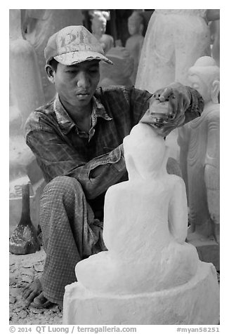 Sculptor carving buddha statue out of a block of white marble. Mandalay, Myanmar (black and white)
