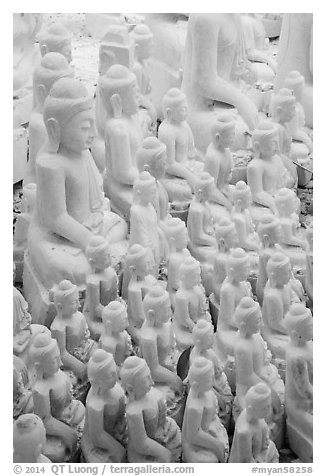 Unfinished white marble buddha statues of various sizes. Mandalay, Myanmar (black and white)