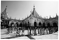 Novices and families walk in procession during Shinbyu ceremony, Mahamuni Pagoda. Mandalay, Myanmar ( black and white)