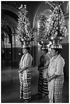 Women carry elaborate flower offerings on their head, Mahamuni Pagoda. Mandalay, Myanmar ( black and white)