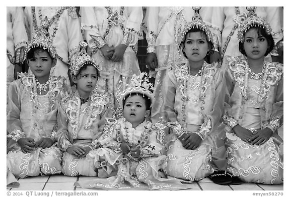 Girls and boy dressed in glittering clothes and make-up to look like princes, Novitiation, Mahamuni Pagoda. Mandalay, Myanmar (black and white)