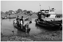 Passengers disembark from boat after short crossing. Mandalay, Myanmar ( black and white)