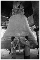 Boy and girl ringing huge bell, Mingun. Myanmar ( black and white)