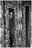 Monk pearing from window, Shwe In Bin Kyaung pagoda. Mandalay, Myanmar ( black and white)