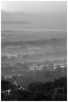 Fog shrouded plain below Mandalay Hill at sunrise. Mandalay, Myanmar ( black and white)