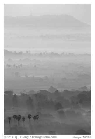Ridges in mist at sunrise seen from Mandalay Hill. Mandalay, Myanmar (black and white)