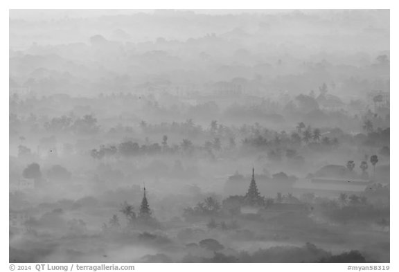 Pagodas and tree ridges in mist as seen from Mandalay Hill. Mandalay, Myanmar (black and white)