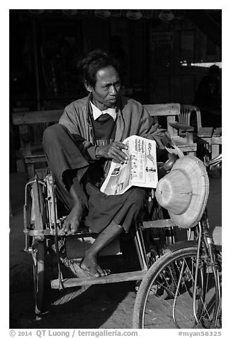 Sai kaa driver sitting on his rickshaw. Mandalay, Myanmar (black and white)