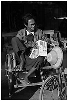 Sai kaa driver sitting on his rickshaw. Mandalay, Myanmar ( black and white)