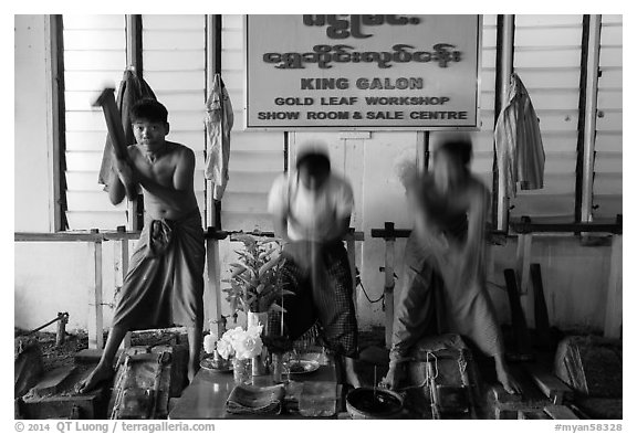 Men beat sheets of gold, gold leaf workshop. Mandalay, Myanmar (black and white)