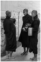 Three monks conversing at Mahagandayon Monastery. Amarapura, Myanmar ( black and white)