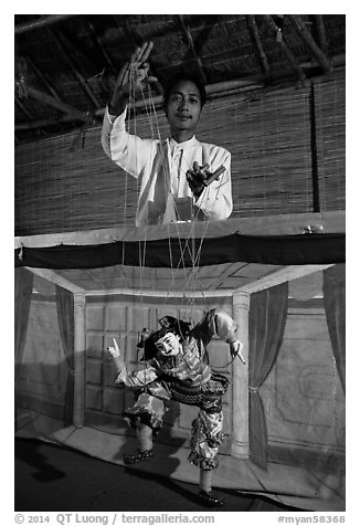 Puppeter handling traditional burmese string marionette. Mandalay, Myanmar (black and white)