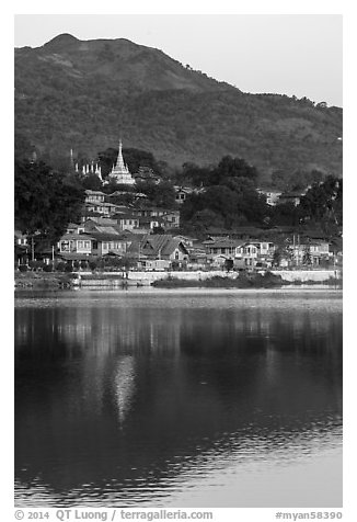 Hill and town reflected in Pone Tanoke Lake at dawn. Pindaya, Myanmar (black and white)