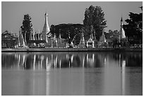 Pagoda reflected in Pone Tanoke Lake at sunrise. Pindaya, Myanmar ( black and white)
