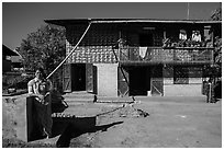 Woman in front of house. Pindaya, Myanmar ( black and white)