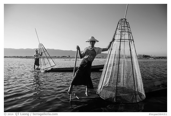 Intha fishermen with conical baskets in warm afternoon light. Inle Lake, Myanmar (black and white)