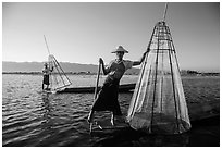 Intha fishermen with conical baskets in warm afternoon light. Inle Lake, Myanmar ( black and white)