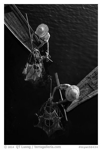 Intha fishermen use spear to stir weed and expose fish. Inle Lake, Myanmar (black and white)