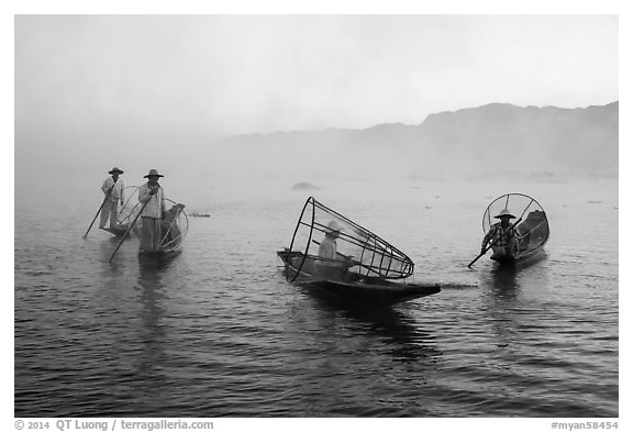 Group of Intha fishermen on misty waters. Inle Lake, Myanmar (black and white)