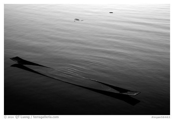 Sunken canoe and rippled water. Inle Lake, Myanmar (black and white)