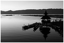 Deck, pavillion, and longtail boats at sunset. Inle Lake, Myanmar ( black and white)