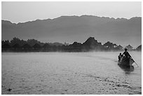 Boat leaving resort in dawn mist. Inle Lake, Myanmar ( black and white)