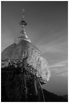 Monk standing on Golden Rock looks into the valley. Kyaiktiyo, Myanmar ( black and white)