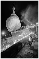 Offerings to the Buddha continues throughout the night at the Golden Rock. Kyaiktiyo, Myanmar ( black and white)