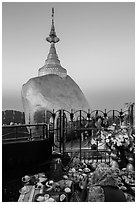 Pilgrim and food offerings behind Golden Rock at dawn. Kyaiktiyo, Myanmar ( black and white)